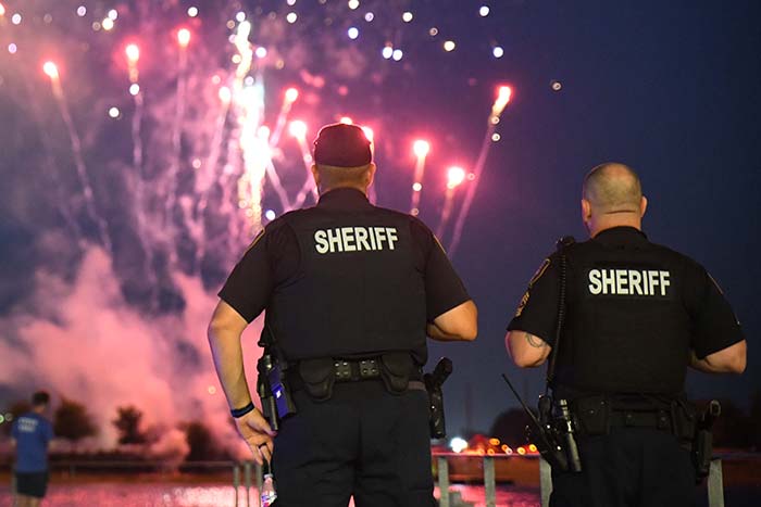 two sheriffs watching a fireworks show